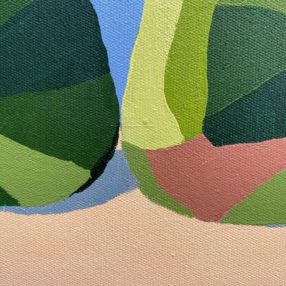 3 green pears in a row on a peachy coloured surface before a cool grey background.