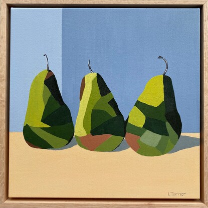 3 green pears in a row on a peachy coloured surface before a cool grey background.