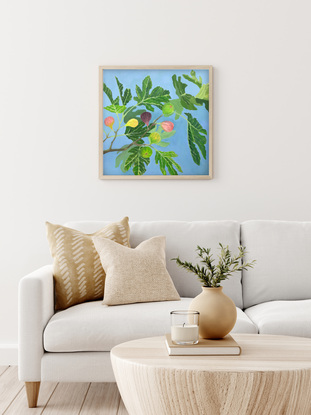 Green fig leaves and colourful figs on a branch with light blue background. 