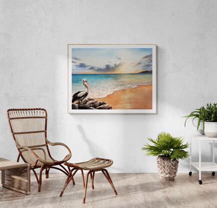 A pelican gracefully perches on a cluster of rocks, overlooking a stunning beach during a radiant sunset. Inviting viewers to pause and reflect, embracing the beauty of nature and finding solace in its tranquil moments.