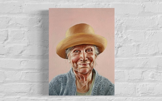 woman in yellow hat on pink background