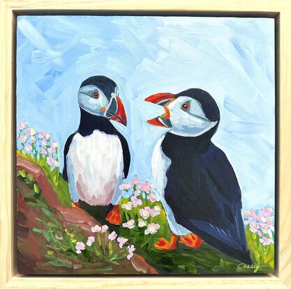 An oil painting of two puffins.