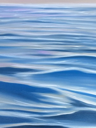 Moving water with reflections from a bright pink and blue sky