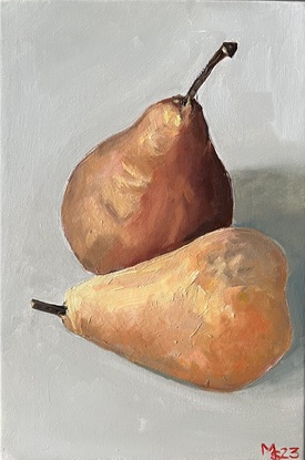 Two brown pears sitting next to each other on an off white background