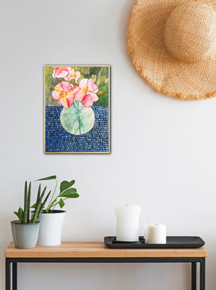 Glass vase of pink peonies, sits on a dark tile like tablecloth across a dark green background. 