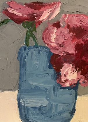 Red and pink flowers in blue pot