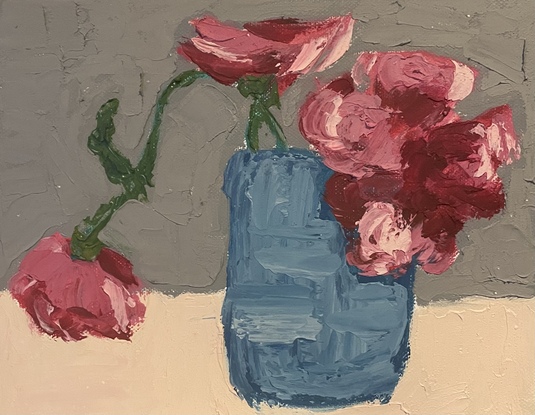 Red and pink flowers in blue pot