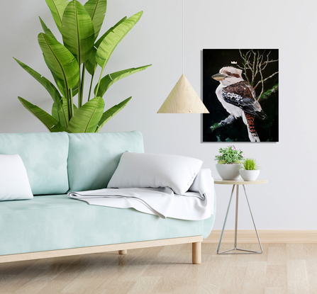 A kookaburra sitting on a branch with a small crown above his head.