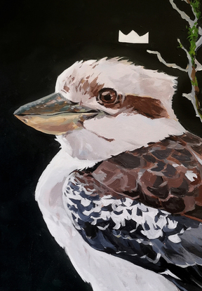 A kookaburra sitting on a branch with a small crown above his head.