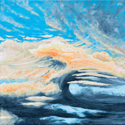 A stormy cloud is being lit from above by the setting sun revealing puffs of yellow orange vapours above a grey base. It floats in front of an otherwise clear blue sky.