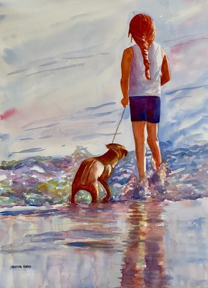 Girl stands with her dog looking out to sea.