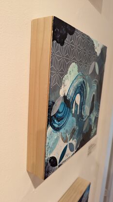 A painting in turquoise and blue featuring cloudlike forms, various geometric patterns and a brushstroke winding through the piece to symbolize wind and waves