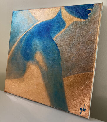 A reverse image in blue of a woman in profile painted on foil.