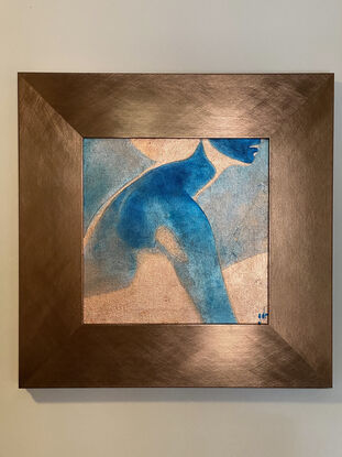 A reverse image in blue of a woman in profile painted on foil.