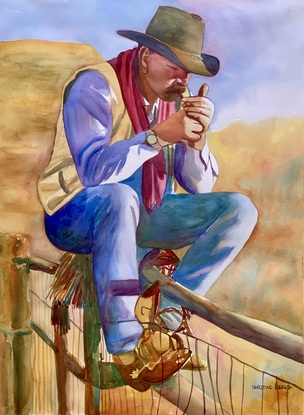 A cowboy smoking whilst sitting on top of a ranch fence.