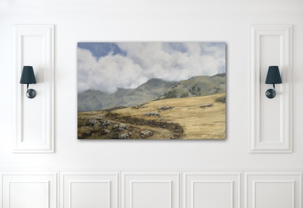 Wheat coloured grassy fields with billowing white fluffy clouds.