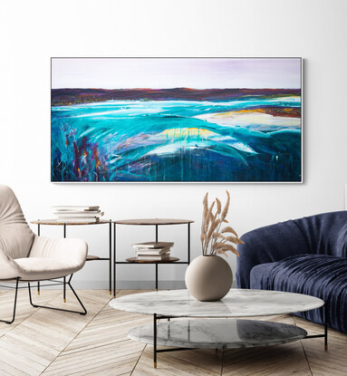 Colourful abstract seascape  with rocky mountain outcrop, blue sky, rolling countryside and crisp blue water with texture and mark making.
