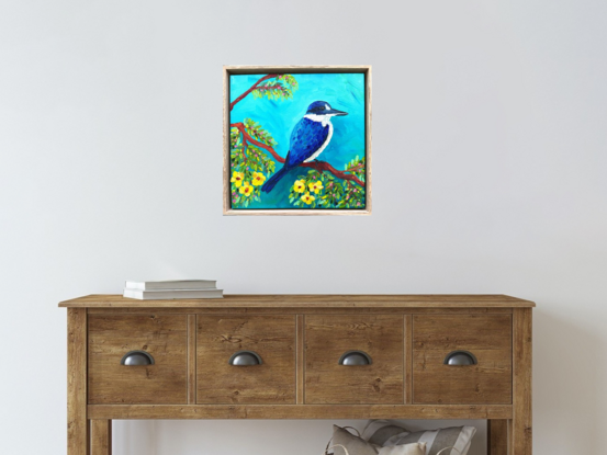 An oil painting of a blue Kingfisher bird amongst yellow Jacaranda flowers.