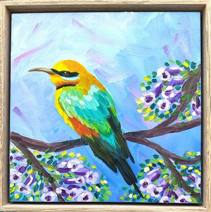 A bright Rainbow Bee-eater amongst Jacaranda flowers.