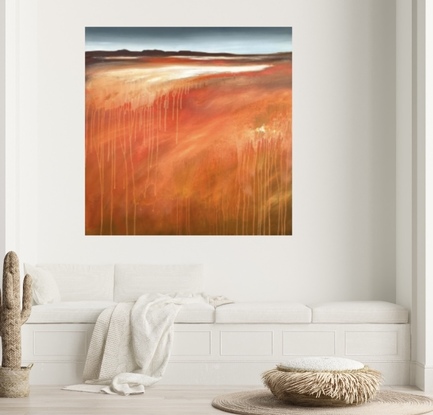 A square abstract landscape in shades of red,red gold and white dripping paint featuring a small mountainscape at the top under a blue and cloudy sky.