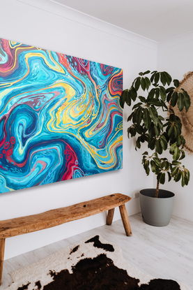 Flowing, gestural lines of blue, pink, yellow, teal, and orange to create swirling patterns reminiscent of the ocean