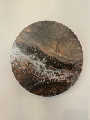 Percolating Valley is a 40cm round abstract acrylic canvas with mixed media. Warm earthen tones of deep brown and ochre hues blend with pearlescent white as a storm clouds percolate over an aerial view of the rich valley soil. 