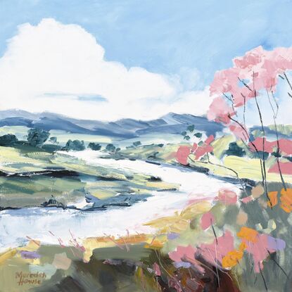 A small stream winding its way through the landscape with a pink blossom tree.