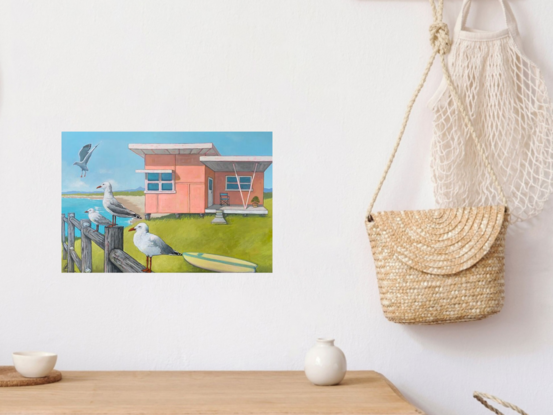 Beach shack on bluff overlooking the ocean with seagulls on the fence.