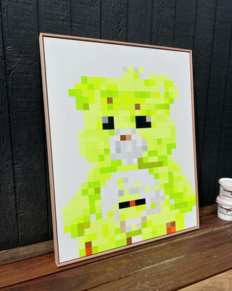 Neon lime green pixelated teddy bear sitting on a white background