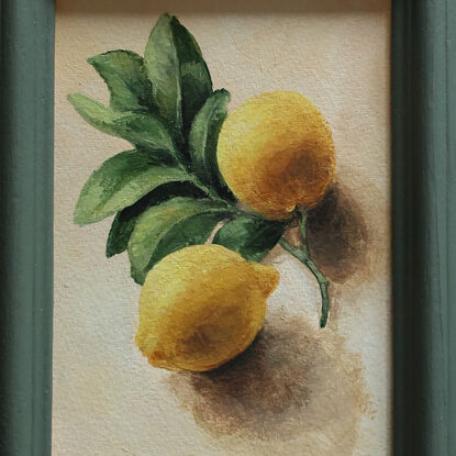 Still life of lemon branch with leaves and lemons.