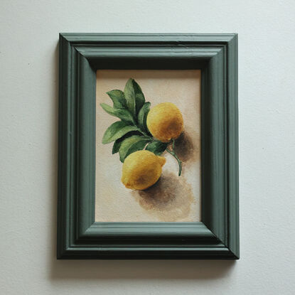 Still life of lemon branch with leaves and lemons.