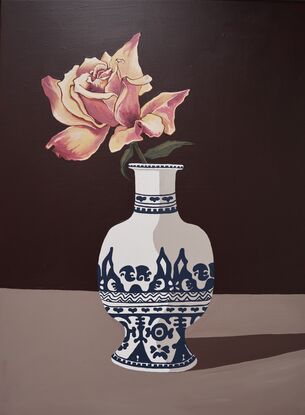 Orange rose in an blue and white vase on a dark background