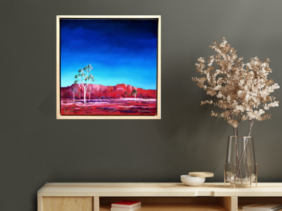 Australian landscape in blues and reds with white ghost gums in the foreground