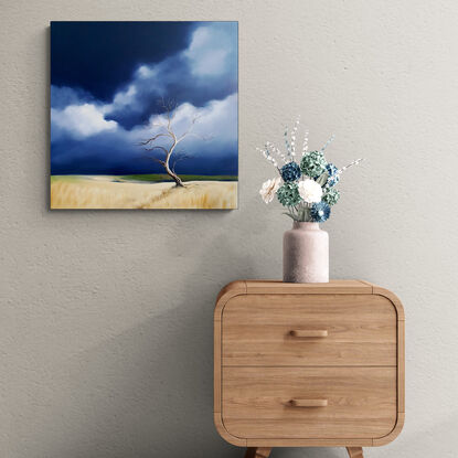 Australian landscape in blues and beige with a stormy sky and old gnarled tree