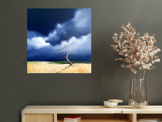 Australian landscape in blues and beige with a stormy sky and old gnarled tree