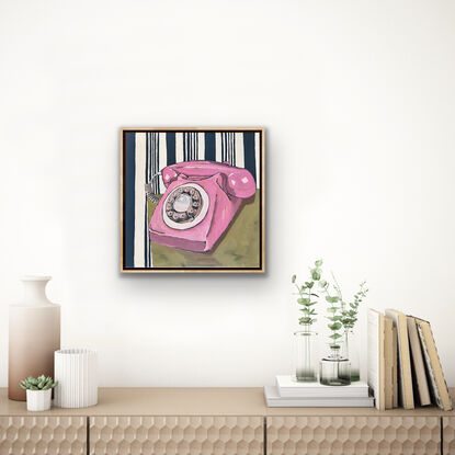 Pink vintage telephone with dial and navy stripe wallpaper