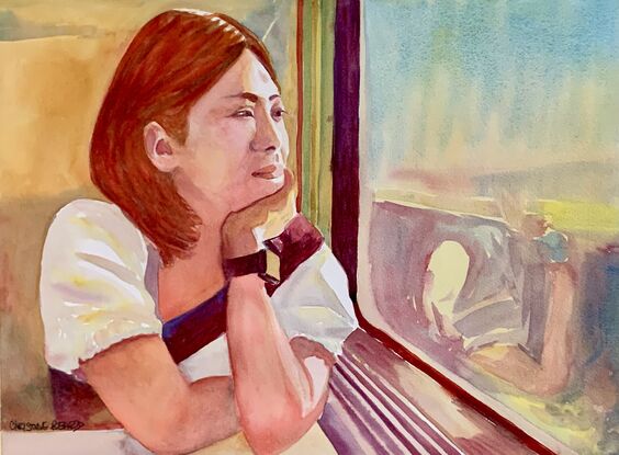 Woman gazes out from a train window.  
