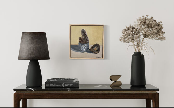 brown seed pods feather in metallic vase