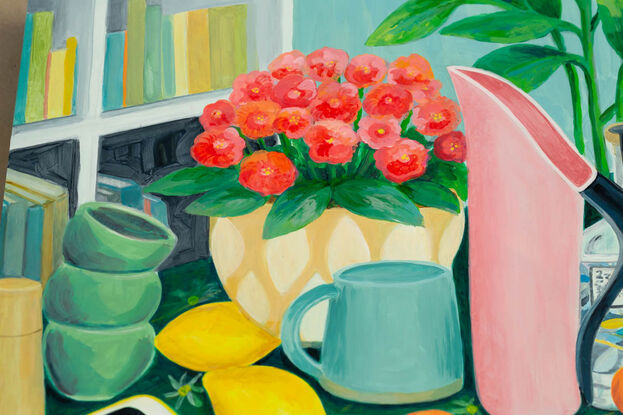 Table scene of pink Fink jug, gin bottle, potted plant, mug and lemons and mandarins. An i-phone sits on the table on the left on a green tablecloth and a camera and sugar bowl are on the right hand side. There is the suggestion of a bookshelf in the background.