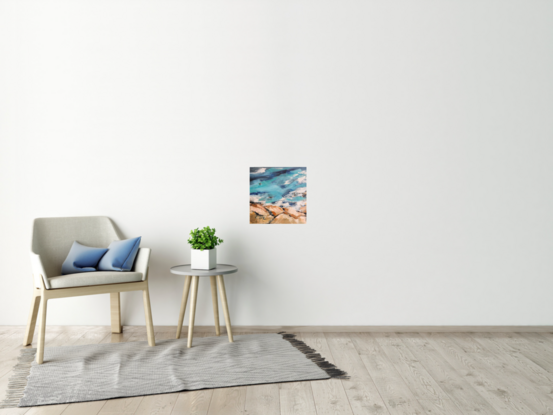 Surfers in azure waves, rocky shore.