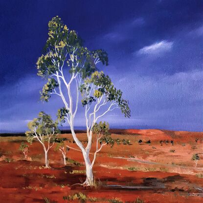 Australian landscape in yellows, oranges and deep blue sky with a road and gum trees, dust storm coming