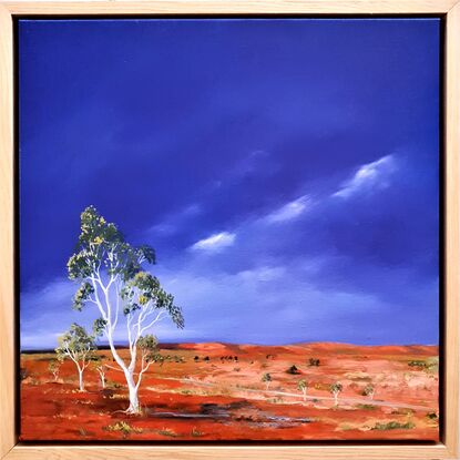 Australian landscape in yellows, oranges and deep blue sky with a road and gum trees, dust storm coming