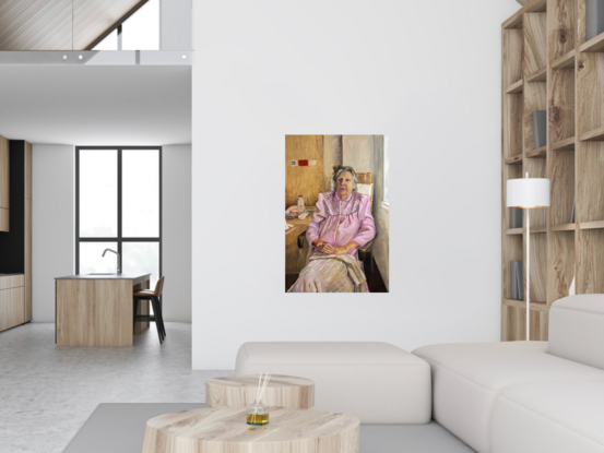 Old woman wearing a pink robe sitting on an armchair in a hospital room