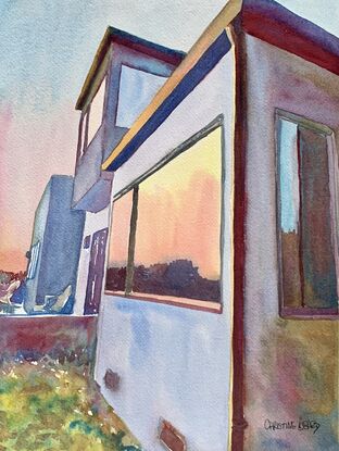 Sunset reflected in the windows of a house.
