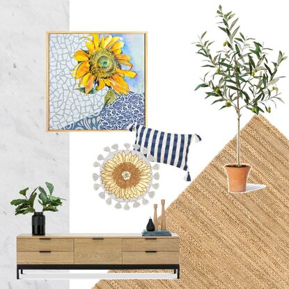 A single sunflower, facing towards the viewer, is created using watercolour. It sits in a blue and white detailed vase, on a blue and white tablecloth - both created using collaged paper. The background is a white, geometric, marble-like texture, also created in collaged paper. 