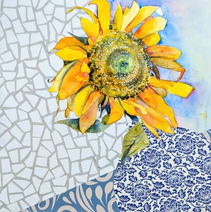 A single sunflower, facing towards the viewer, is created using watercolour. It sits in a blue and white detailed vase, on a blue and white tablecloth - both created using collaged paper. The background is a white, geometric, marble-like texture, also created in collaged paper. 