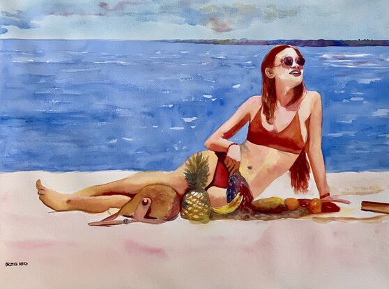 Woman reclines on the beach.