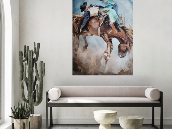 Close up of a cowboy in turquoise chaps riding a wild bucking horse in rodeo. Dust and fast action