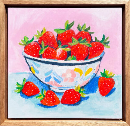 a textural bowl of strawberries with a pastel pink and blue background. 