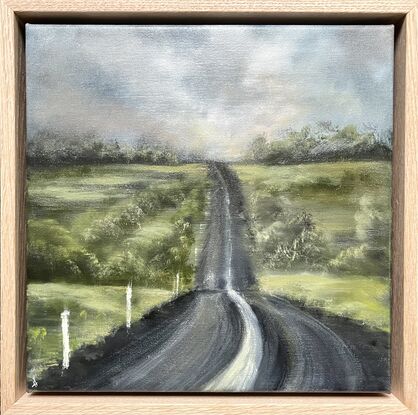 Warm dusk storm clouds over pasture and country road.  